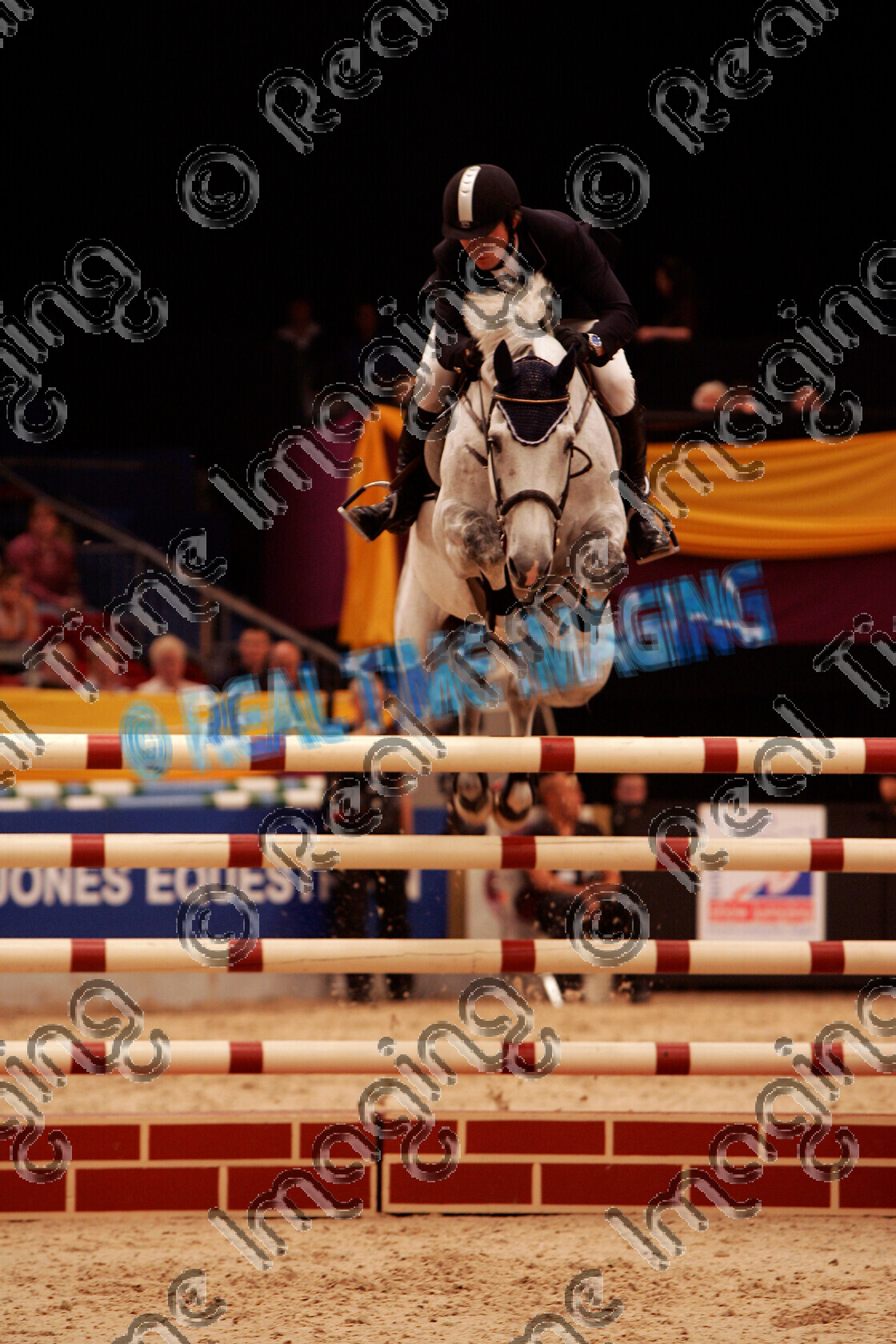 S05-65-10-026 
 HOYS 2005: The Thomas Bates & Sons Classic Winner 
 Keywords: horse of the year show 2005 05 hoys october showjumping showjumper 10 jump jumping fence action 1316 Thomas Bates & Sons Classic Winner 88 al madoob james paterson robinson grey gray gelding thursday