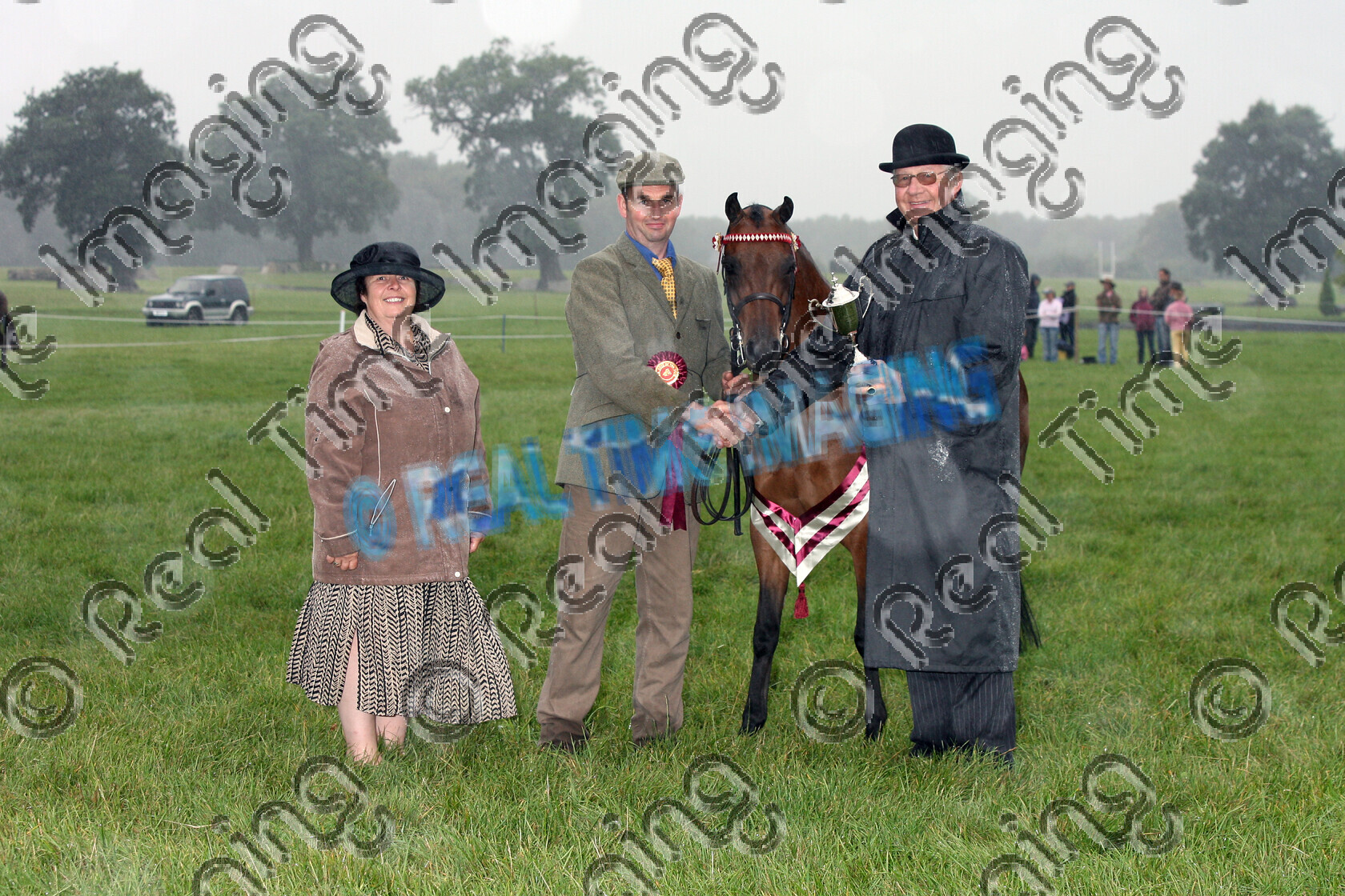 S07-57-04-051 copy 
 Keywords: Sunday, 2 September, 2007, NCPA Pony Of The Year Show, Somerford Park, Cheshire, UK, 827, ROYAL VIEW TOYBOY, Presidents Cup, In Hand, Championship, Champion, winner win won, `Owner: , Roberts, Andrea & Shirley, `Handler: , Gwyndaf Owen, Part Bred Arab, Bay, Gelding, view landscape, brow band, stand, presentation, Rosette, sash, trophy, Presented By: , Mr John Careless, rain storm wet weather