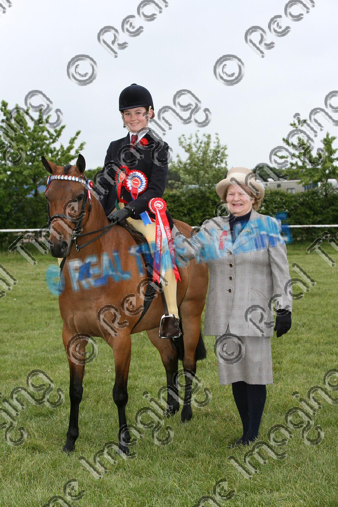 S07-23-01-157 
 Keywords: Presented By: Mrs A M Barton OBE stand presentation Show Pony Championship Bay mare May 2007 Newark & Nottinghamshire County Show 587 STANLEY GRANGE ROULETTE upright portrait Owner: Mrs J Gill Rider: Charlotte Gill Champion child rider Rosette winner win won