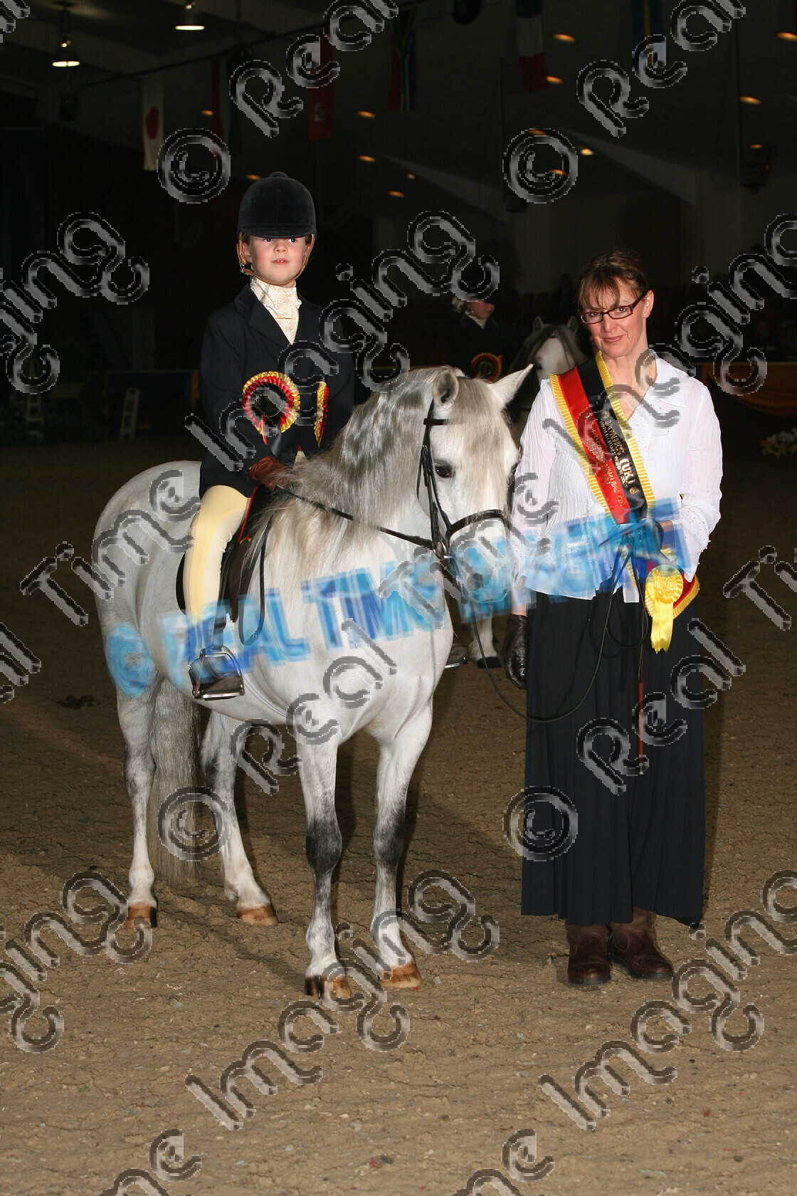 S07-08-18-031 
 Keywords: stand stood 281 TELAID PLAYFUL Novice M&M Mountain Moorland Mini Champion Lead Rein Welsh Section A Grey Gray Mare Winter Championships Ponies (UK) Unex Towerlands Jenny Morris Child rider horse pony showing Indoors Rosette winner won