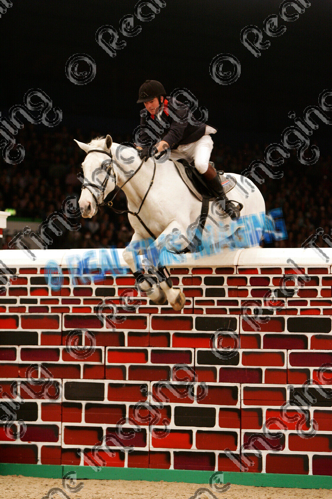 S05-67-12-063 
 HOYS 2005: The Horse Of The Year Show Puissance Winner 
 Keywords: horse of the year show 2005 05 hoys saturday 15 10 october showjumping showjumper 23 Puissance Winner 2 Lactic John Whitaker grey gray gelding jump jumping fence action wall