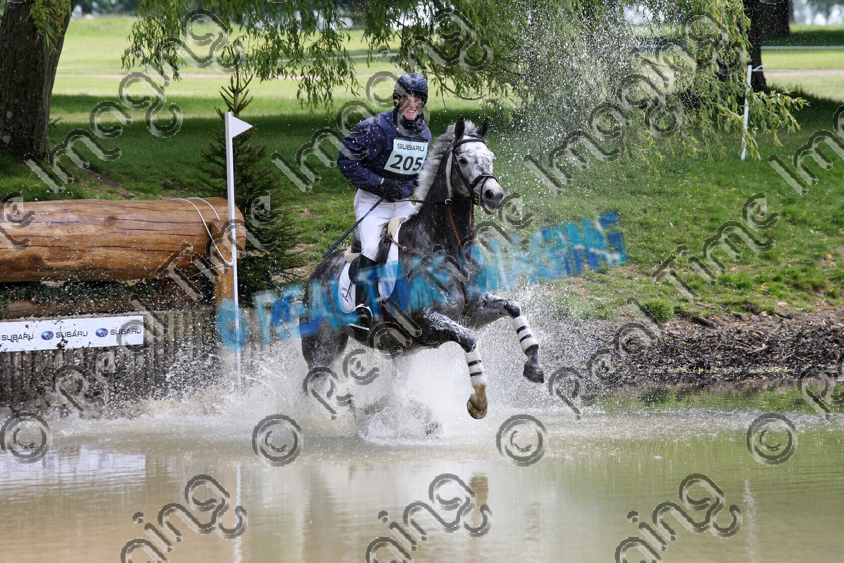 L01-01-01-026 
 205 
 Keywords: Houghton International 3 Day Event, Norfolk, UK, Saturday, 24 May, 2008, view landscape, Subaru, CCI** two star, cross country, 205, LINNEL DANCING TIGER, `Owner: , Charlton, Mr and Mrs, `Rider: , Angus Smales, dark, dappled grey gray, Gelding, water crossing splash, flat, Canter, horse equestrian equine sport