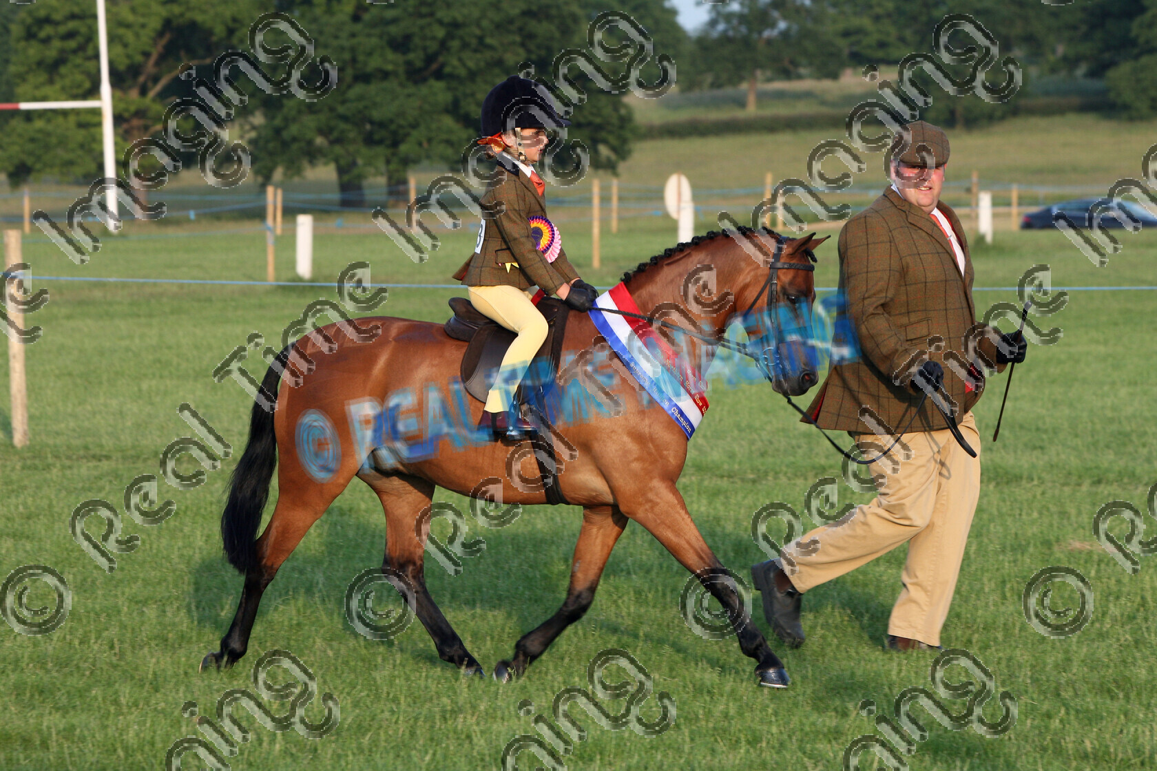S09-29-15-043 
 Keywords: The Northern Horse Show, Grange Park, Wetherby, North Yorkshire, UK, Sunday, 28, June, 2009, view landscape, Supreme Ridden Championship, Supreme, Mini, Championship, 1st first, Champion, winner win won, 323, CARIDINES LITTLE LORD, `Owner: , Hulbert, Mr R, Vasey, Mr R, `Rider: , Olivia Vasey, Bay, lead rein, Show Hunter Pony SHP, child rider, sash, Rosette, trot, lap of honour, flat