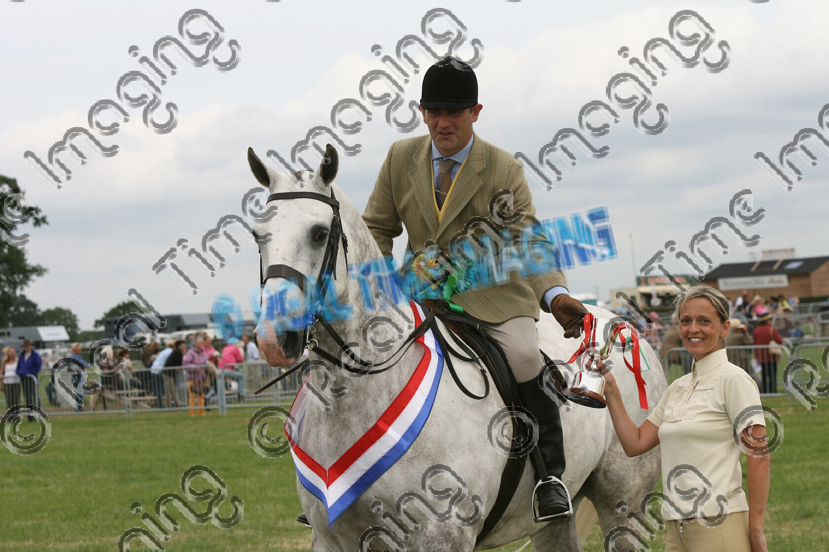 S07-30-3-175 
 Keywords: 178, BILLY WHIZZ III, Amateur, Cob, Championship, Champion, winner win won, `Owner: , `Rider: , Richard Holt, June 2007, Cheshire County Show, Tabley, Knutsford, Cheshire, dappled grey gray, Presented By: , Sue Hinchcliffe, Rosette, trophy, presentation, stand, view landscape, close up, sash, horse pony, Lightweight, Ridden