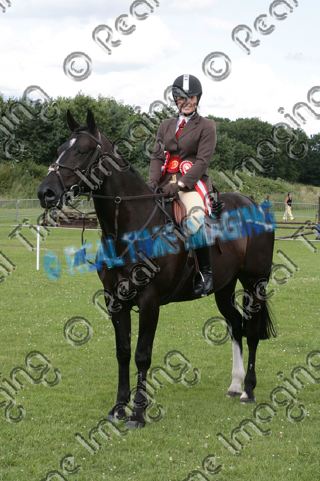 S09-31-M5-045 
 Keywords: NCPA Staffordshire Country Festival, Staffs, Walsall Airport, Aldridge, UK, Sunday, 5, July, 2009, upright portrait, HOYS, Open, Working Hunter, Championship, 1st first, Champion, winner win won, 485, CARNSDALE TOP GUN, `Rider: , Joanne Shaw, Rosette, stand, presentation