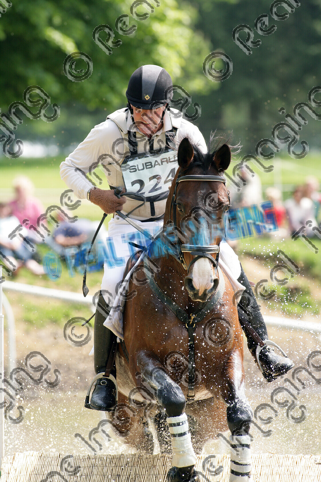 L01-01-01-183 
 224 
 Keywords: Houghton International 3 Day Event, Norfolk, UK, Saturday, 24 May, 2008, upright portrait, Subaru, CCI** two star, cross country, 224, OSCAR KNIGHT, `Owner: , Hassett, Mrs Sandra, `Rider: , Nigel Taylor, Bay, Gelding, jump, fence, water crossing splash, close up, horse equestrian equine sport